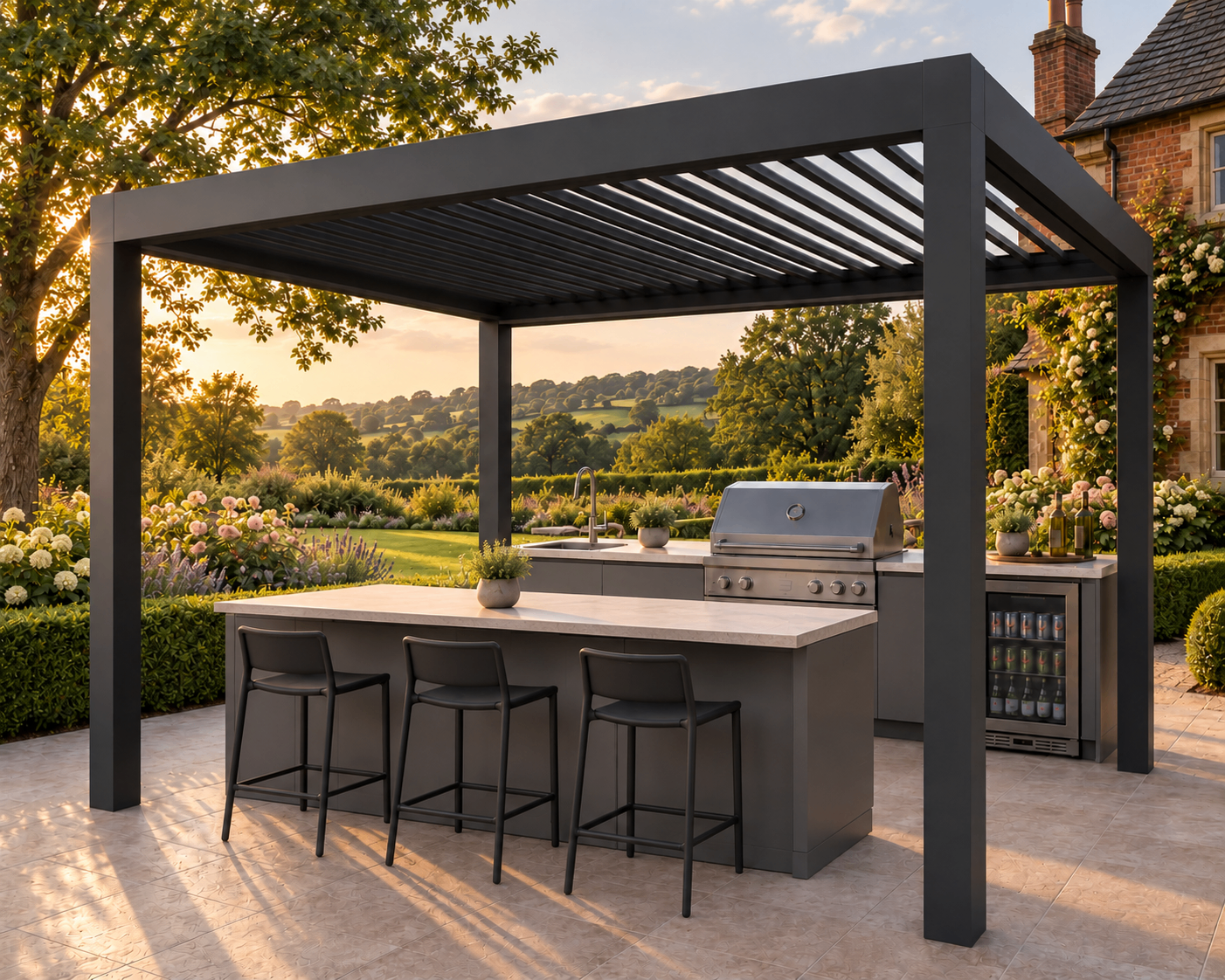 The Signature Entertainer - stone island bar with stools, outdoor kitchen and anthracite pergola in an English country garden at sunset